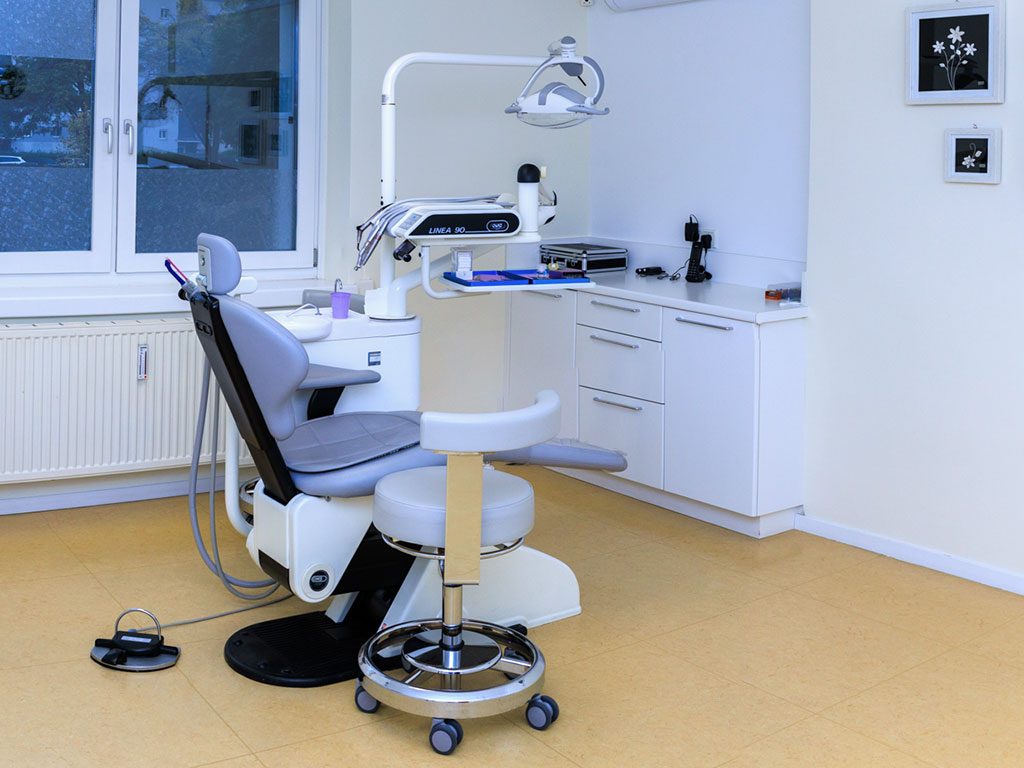 Helles, modern ausgestattetes Behandlungszimmer mit zahnärztlichem Behandlungsstuhl in der Zahnarztpraxis von Dr. Bahar Pishan